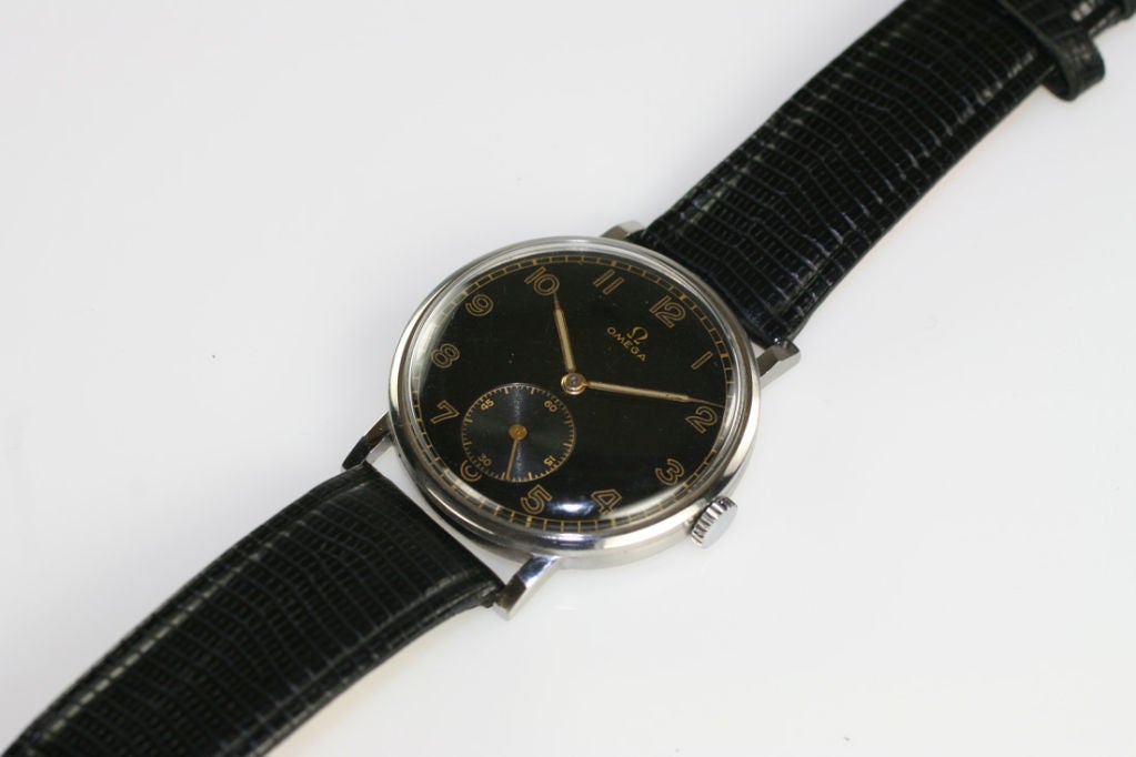 Vintage Omega dress watch in stainless steel, original black dial with subsidiary seconds at the 6 o'clock.