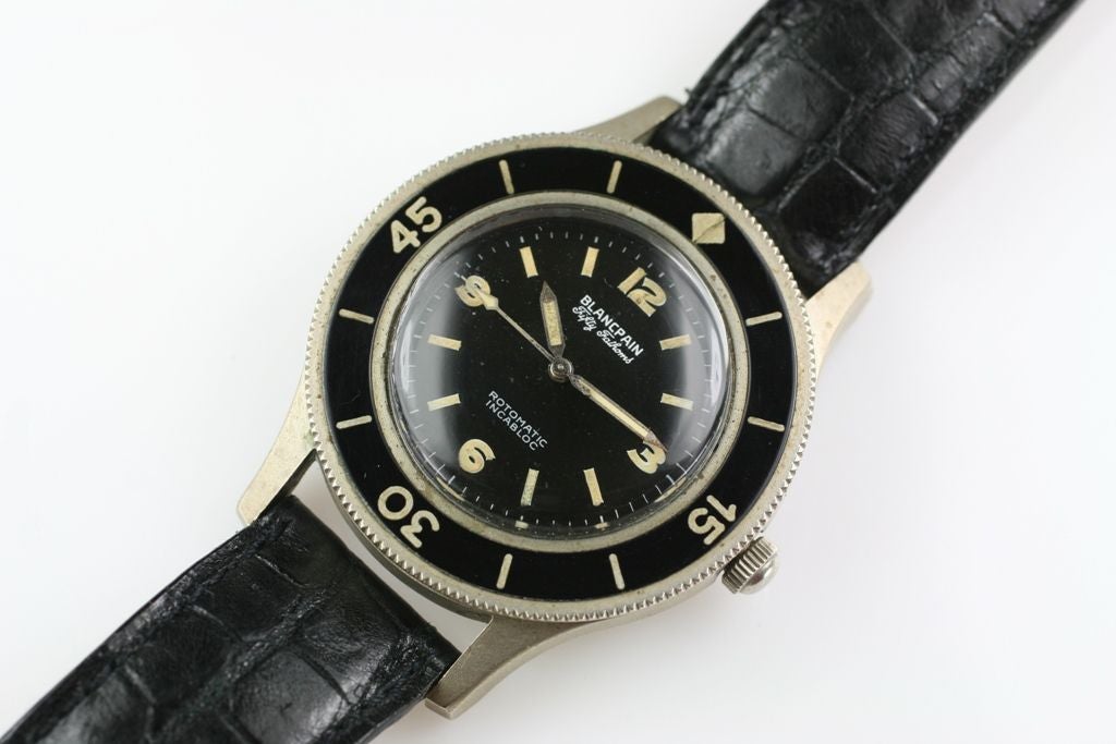 Blancpain Fifty Fathoms Rotomatic Incabloc milspec was one of the first modern dive watches from the 1950's. It has a bi-directional rotating bezel and plastic crystal.