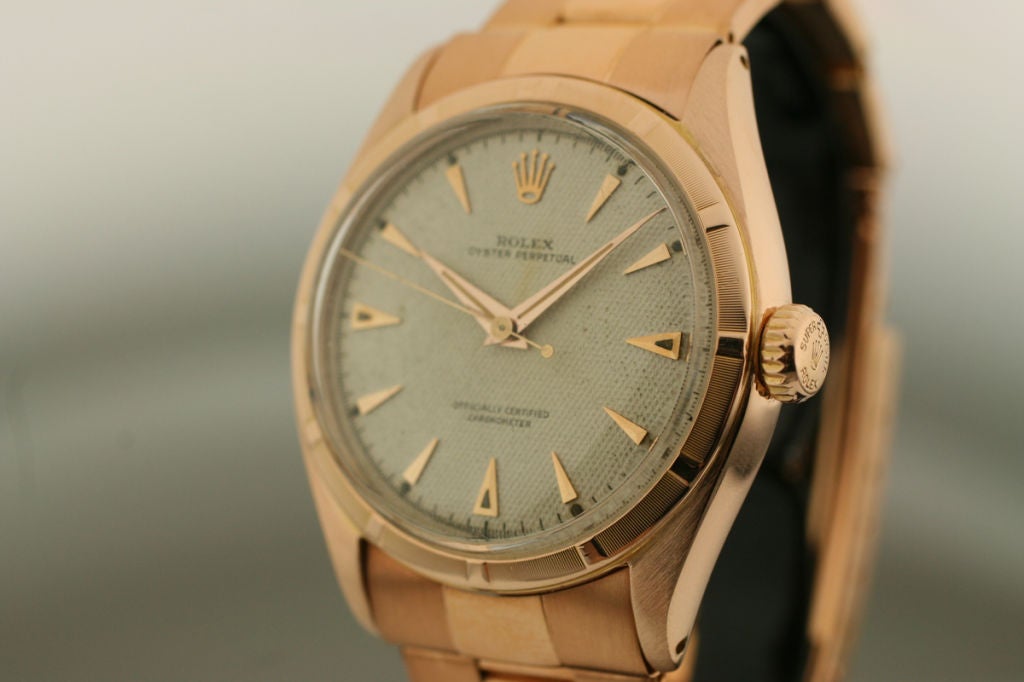 This is a beautiful Rolex oyster perpetual semi-bubble back in 18k rose gold with a original honey comb dial on a Rolex 18k rose gold rivet bracelet