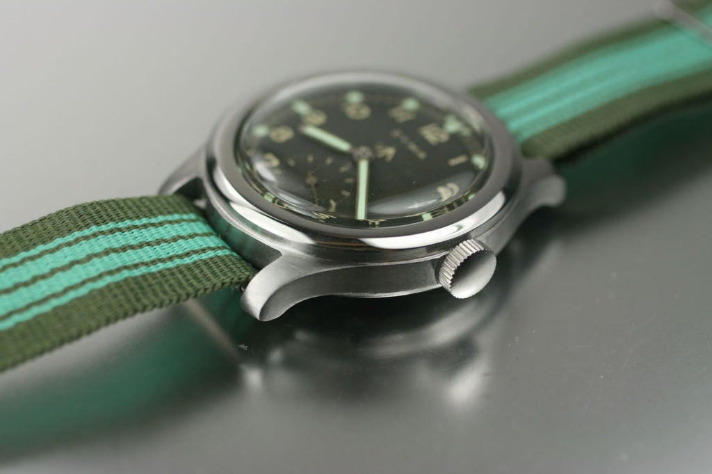 This is a Broad Arrow (British Military, WWII) by Cyma. The stainless steel 38mm case has a screw back case with dust cover for the manual wind movement.