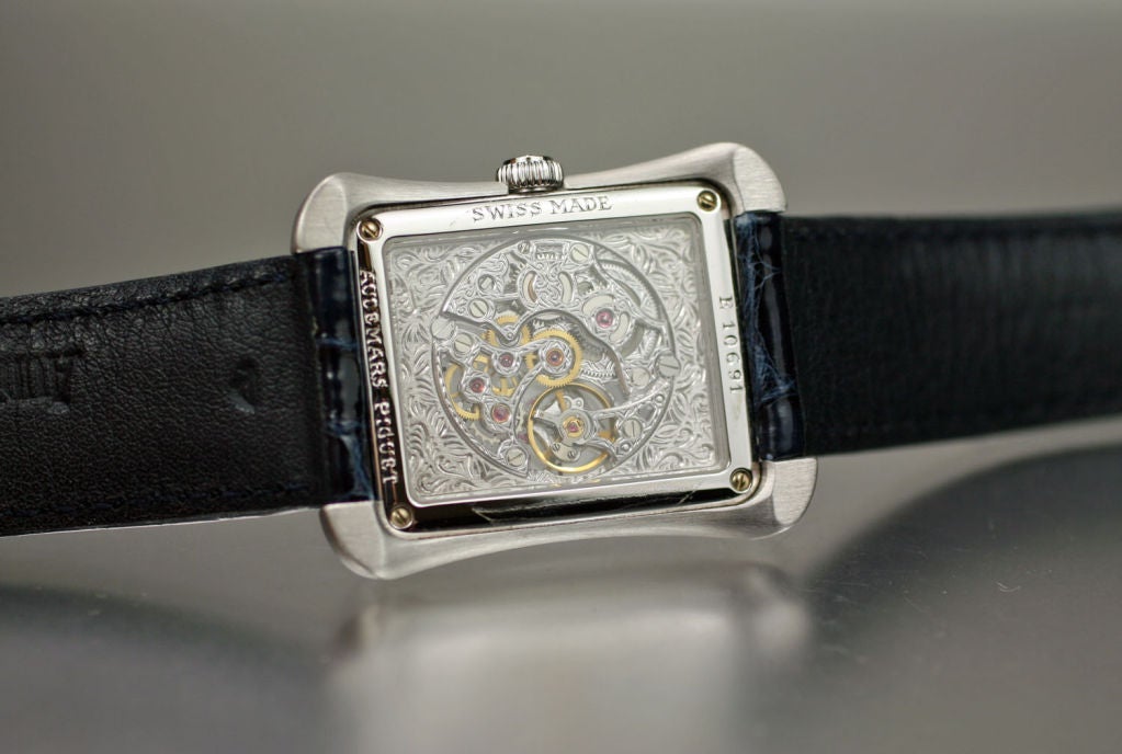This is a beautifully designed Audemars Piguet 18k white gold skeleton watch. The dial/movement are hand engraved with an integrate motif. The watch comes with a dark blue Audemars Piguet strap, 18k white gold AP buckle, box and papers.