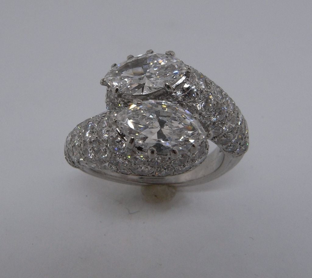 An outstanding diamond Toi et Moi ring by Cartier Paris.  This beautiful ring is set with two major marquise diamonds weighing 0.97 carats and 1.11 carats.  The body of the ring is set with 82 smaller brilliant cut diamonds with a combined weight of