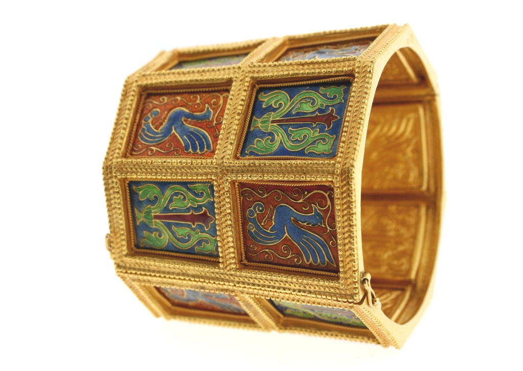 Truly unique 22k gold hinged cuff bracelet consisting of beautifully enamelled plaques of a muted green, blue and cinnamon palette possibly depicting the Greek mythological Phoenix and Lyre. Each plaque is also engraved on the back. The gold work