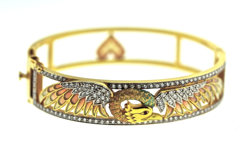 An exquisite plique a jour enamel and diamond matte 18k gold hinged bangle bracelet of a falcon like motif. This is such a quintessentially feminine piece of jewelry in the style of the art nouveau period. Masriera has been making fine jewelry in