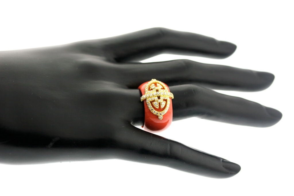 A lovely band carved from one piece of coral with an 18k gold diamond set design, created by and signed Henry Dunay. Very elegant and extremely comfortable. Size 7.5. Can be made smaller but not larger.