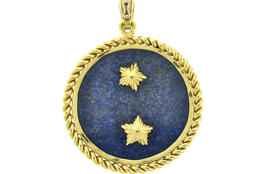 A fabulous zodiac medallion from the 1970s by Van Cleef & Arpels. The symbol for cancer, the crab, is set in 18k gold with ruby eyes and a single diamond and mounted on lapis stone. The bale opens and closes allowing this pendant to be worn on