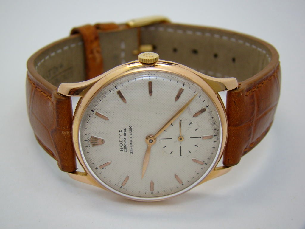 An 18 Karat Pink Gold Watch sold by 'Serpico y Laino' by Rolex - sub-second hand, honey-comb dial, circa 1940, signed Rolex