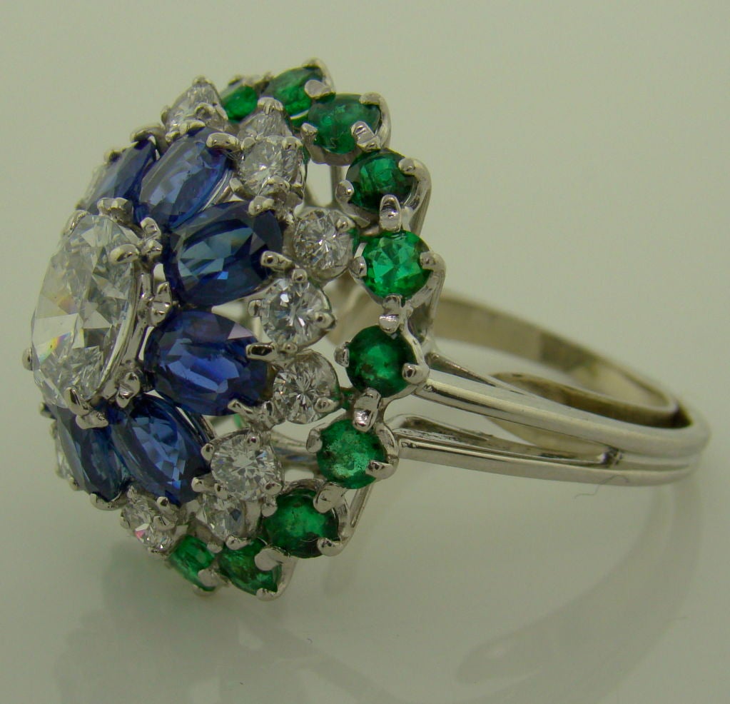 A Platinum, Diamond, Sapphire & Emerald Ring by Oscar Heyman - 1.38 Carat Center Diamond & 1.18 Surrounding Diamonds, 6.29 carats total of Emeralds & Blue Sapphire
