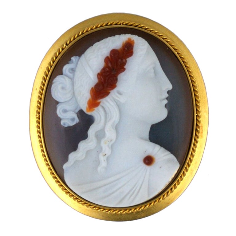 Victorian high relief sardonyx cameo of maiden with hair wreath decoration. The wreath and dress closure are carnelian toned against her alabaster profile. 
Elegantly carved in high-relief this mid-Victorian beauty boasts a highly detailed