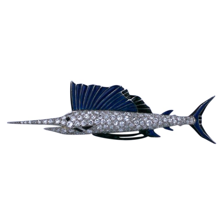 Period Art Deco diamond sailfish brooch. Beautiful quality with pave diamond set body and navy and black enamel accents. Motifs such as this became popular in the 30's and became known as 