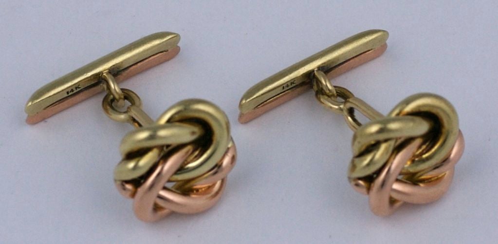 Attractive 2 tone cufflinks in pink and yellow gold. Elegant knot motif with 2 toned bar as well. Heavy quality (8.25 dwt).<br />
Circa 1930s.<br />
Excellent condition