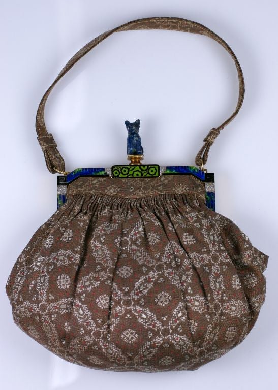 Superb French Art Deco Enamel and Diamond Figural Bag from the 1930's. French 18k gold frame with Art Deco vibrant enamels in black, lime green and faux lapis, edged in minute rose diamond motifs. A mottled sodalite carved puppy serves as a toggle