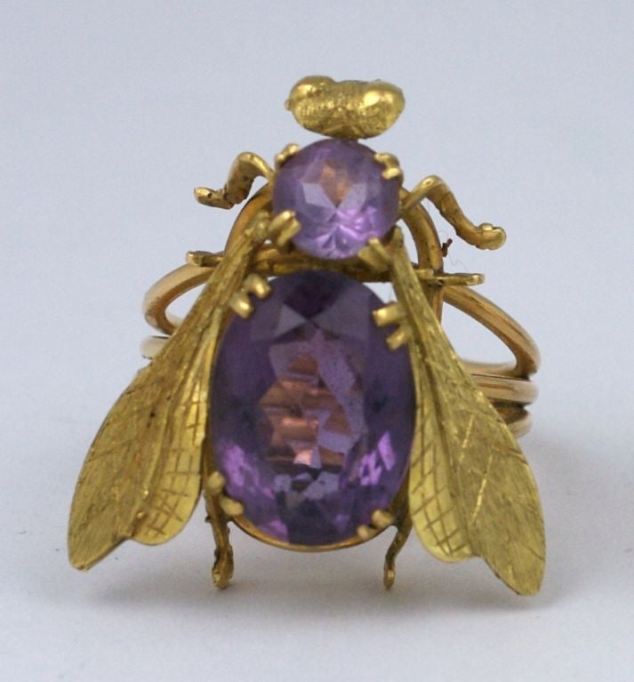 Oversized statement ring from the 1970s in 18K and Amythest. Impressively scaled with large faceted oval amythest (16mm x 12mm)set in the body. A smaller amythest forms the upper body. The gold is finely etched and detailed in the wings, legs and