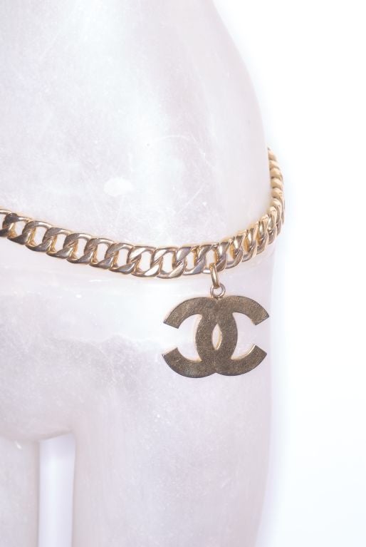 A great classic gilt chain Chanel belt from the early 1990s with a dangling large CC charm.<br />
<br />
Items can also be viewed in our store, RARE vintage, located at 24 West 57th Street between 5th and 6th Avenues on the 5th floor.  Store hours