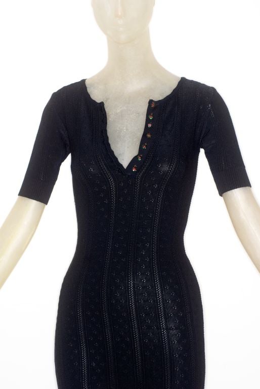 This is a very rare Marc Jacobs for Perry Ellis black crochet knit dress with small round glass buttons with flowers.

Marc Jacobs had a rather infamous and brief tenure at Perry Ellis when he was hired in 1988 as creative director and then