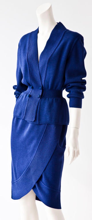 Bottega Veneta royal blue wool knit  2 piece ensemble. Jacket is  fitted at the waist with ribbing and has a peplum. It fastens with rounded twisted self buttons. Wide Ribbing detail runs down front of sweater and at the cuffs. Skirt has a 