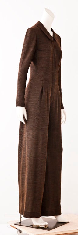 Chanel fine wool tweed jumpsuit with a bit of stretch..<br />
Very fine texture with black, ochre and dark brown threads.<br />
The trouser part is wide and pleated at the hip with side pockets. Front closure has a hidden zipper with 2 breast