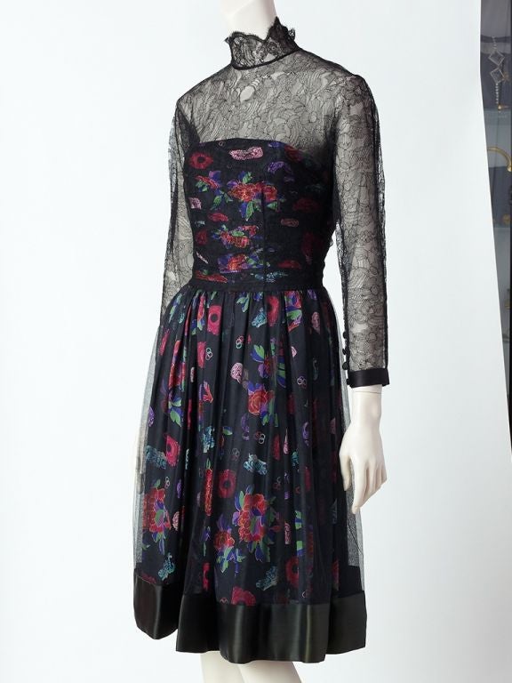 Karl Lagerfeld lace, tulle and printed silk cocktail dress.
Dress bodice is chantilly lace, long sleeved with a high neckline,  and a printed silk charmeuse ruched bustier underpinning. Skirt of dress has a silk charmeuse printed silk, slightly