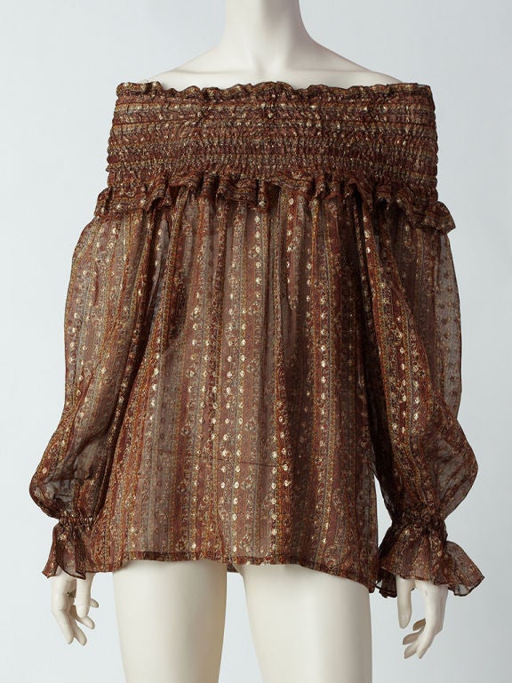Yves ST. Laurent rust colored printed and lame chiffon blouse with smocking at neck, shoulders and cuffs.. This is from his Russian Collection. Blouse can be worn off the shoulders or left<br />
to show more smocking, high at the neck. Lovely full