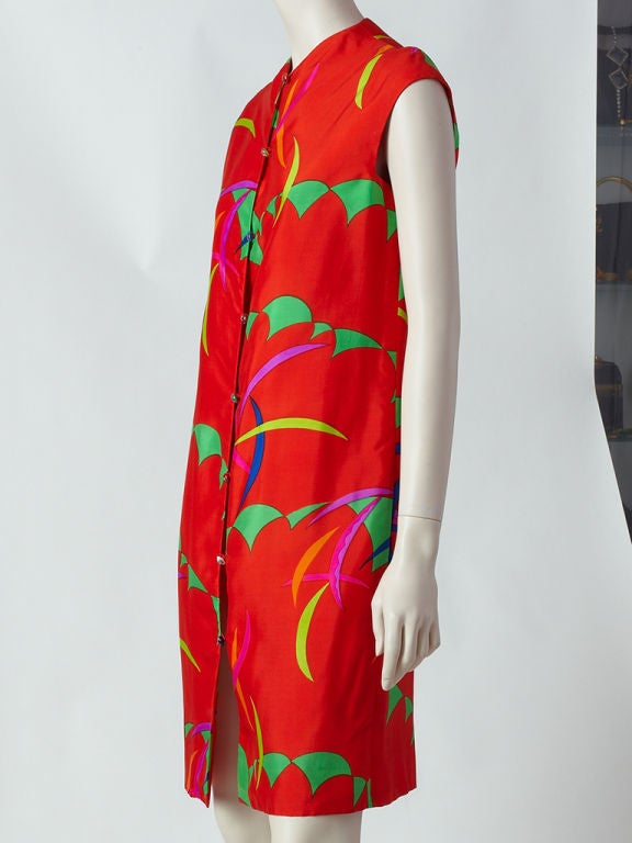 Rudi Gernreich silk Kandinsky pattern button down dress with venetian glass buttons. The dress was inspired from a Kandinsky painting. The background is a rich orange with primary colored abstract patterns in shades of green, fuschia, yellow and