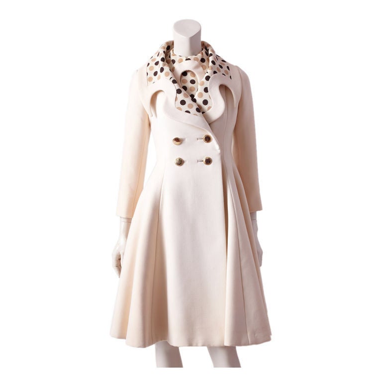 Ronald Amey 2 piece whimsical ensemble consisting of, an ivory wool, double breasted fitted coat, with a full skirt and a wide exaggerated curved collar with an inset of a beige,and chocolate brown polka dot pattern on an ivory ground. Accompanying