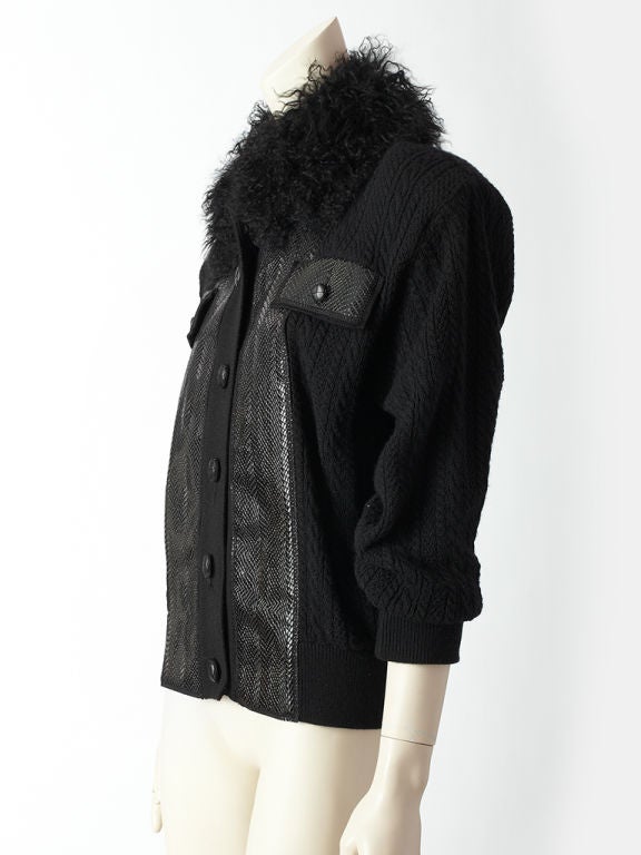 YSl button front, sweater-jacket with a faux leather reptile pattern front panel.Front Panel has breast pockets. The rest of the body of the sweater is a wool cable knit which includes the sleeves, shoulders and back.<br />
The collar is black