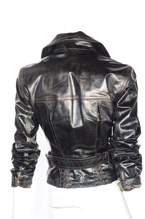 Grace Jones, Naomi Campbell, Stephanie Seymore, Madonna, & Tina Turner where all faithful followers and this sexy patent leather jacket gives a quick glimpse why.<br />
It has a large collar with two side zip pockets and corset lace detail at the