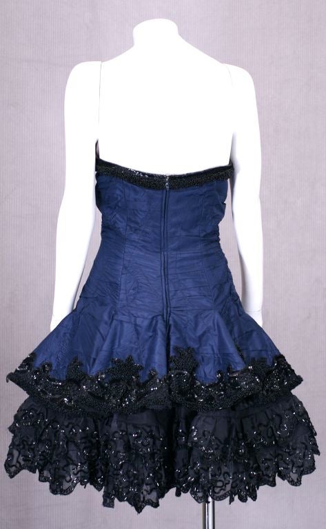 Glamorous Fabrice Cocktail Dress in navy silk taffeta with lavishly decorated jet beadwork, sequins, trim and lace. Heavily ruched silk taffeta built over a corset base with a flared mini over a double petticoat with a lace, sequin and beaded hem.