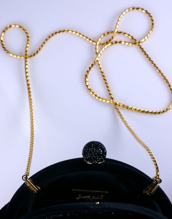 Elegant Judith Leiber clutch?shoulder bag of puckered silk matelasse with jet pave Swarovski crystal accents on both sides of frame and pave ball clasp. Timeless  and versatile with hideable gold shoulder chain.

Excellent Unused condition

8