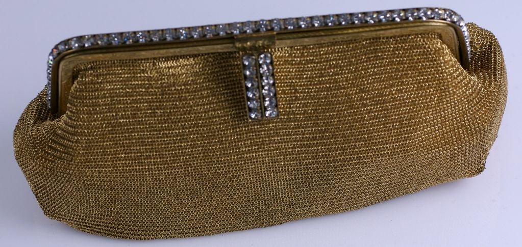 Unusual gilt metal mesh clutch from the 1940's. Paste set frame with paste toggle. Extremely supple mesh lined in peach rayon.<br />
Origin: US Zone Germany<br />
Excellent condition<br />
8" x 4.5" x 1.5"