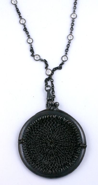 Wonderful crystal long chain from the Victorian era with a charming circular gunmetal mesh purse attached. Purse can be detached from chain so other pendants can be hung or chain can be worn alone. Tight spacing of faceted crystals at 1/2"