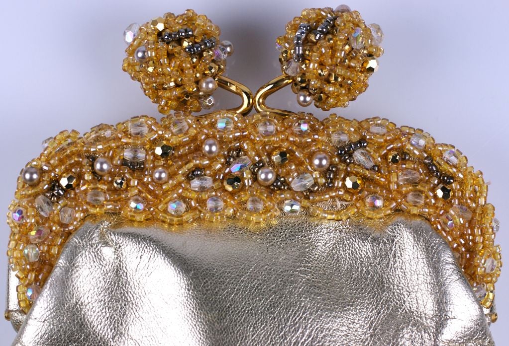 Beautiful Lederer gold kid leather clutch with ornate beaded frame. Frame is beaded on both sides with citrine crystals and pearls. The ball closure is also beaded.<br />
Very slight pin dot mark on one side (see pic 3).<br />
Bag,however, is