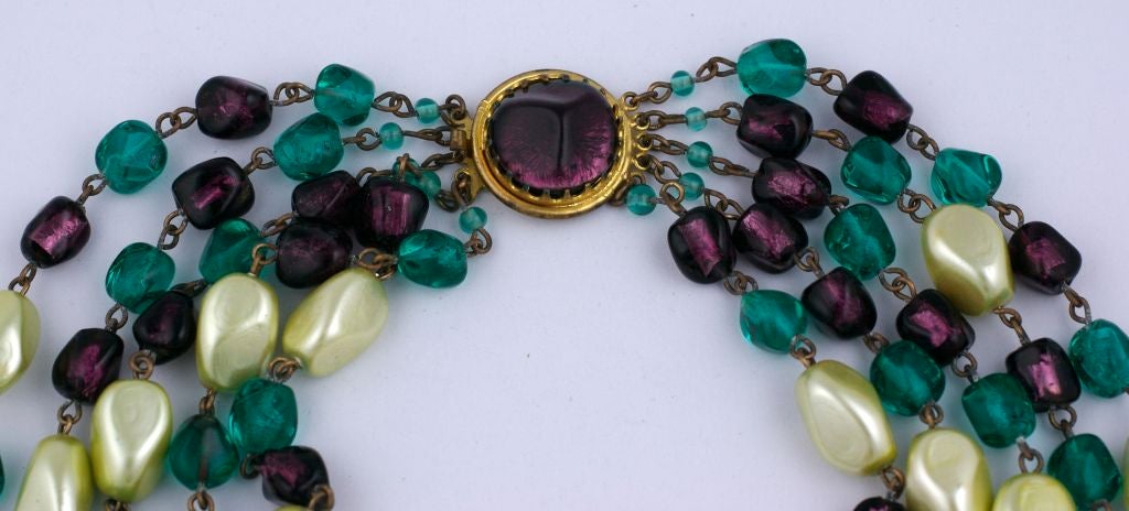 Multistrand necklace of pate de verre beads and faux pearls. Emerald, amythest hand formed poured glass beads are mixed with celadon faux pearls. Made by Maison Gripoix circa 1950s.<br />
Excellent condition.<br />
Marked France<br />
Lengths