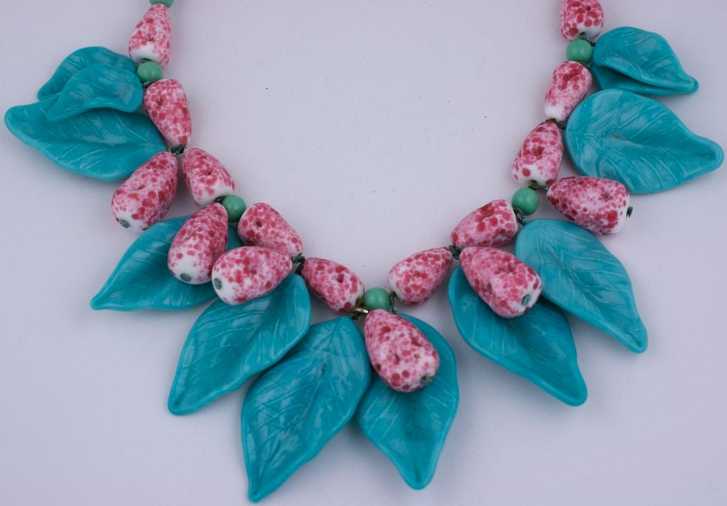 Handmade french necklace of hand made pate de verre fruit beads and leaves. Turquoise leaves with mottled rasberry/milk fruit beads mixed with a paler green turq. glass spacers. Strung on metal foxchain.<br />
Excellent condition, circa 1930s