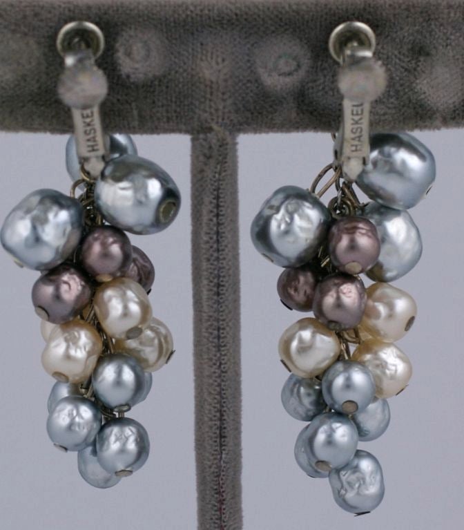 Lovely grape cluster faux pearl earrings by Miriam Haskell in shaded tones of grey, brown, beige and ivory. Adjustable clip back.<br />
Excellent condition.<br />
2