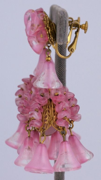 Amazing Miriam Haskell rose colored pate de verre chandelier earrings.Small and large glass morning glories decorate a large oval bead and bell shaped filigree. Signature russian gold plating.<br />
length 2.5" inches, width 1.5"<br