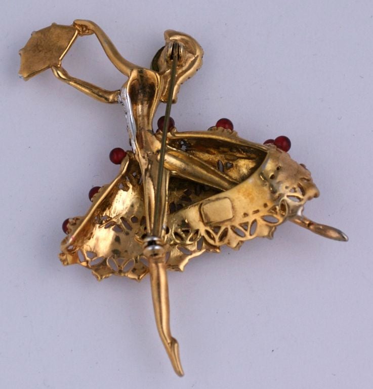 Retro Style Coro Brooch circa 1940s. The yellow gold colored  brooch of a leaping ballerina with faux pearl cabochon face,a bodice of clear pastes and long full skirt of faux ruby beads.<br />
Excellent condition<br />
2