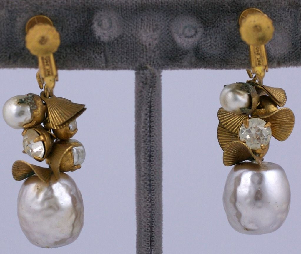 Signature Miriam Haskell baroque pearl,rhinestone and gilt metal shell dangle earrings, length 2 inches.

Adjustable clip back

Very Good condition.