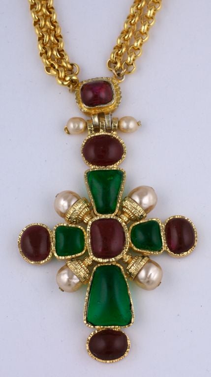 This iconic cross necklace by Karl Lagerfeld for Chanel. Emerald and Ruby poured glass are mixed with faux pearls for this Renaissance style cross. A heavy gilt wheat chain is spaced with ruby beads. <br />
Signed 