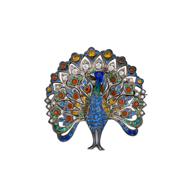 Lovely Peacock brooch hand set with colorful pastes circa 1900,set in sterling silver. The neck and head are enamelled in tones of blue and green. European origin. <br />
Excellent condition<br />
1.75