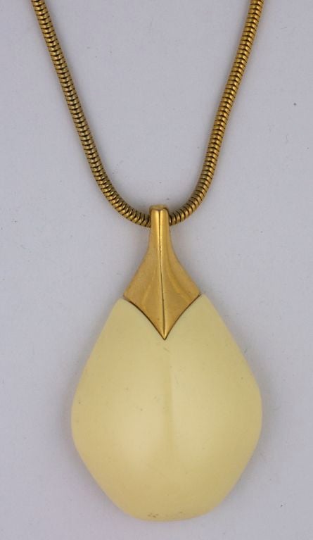 Sleek pendant from Lanvin, Paris. Buttercream bakelite mixed with a gilt snake chain. Very Collectible and striking.<br />
Excellent Condition, <br />
Signed Lanvin, Paris.<br />
Chain: 18