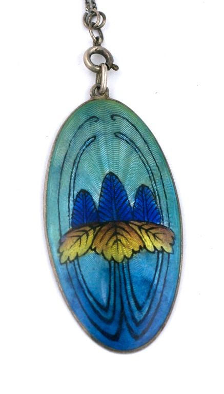 Lovely enamel pendant from the art nouveau period. Scandanavian in origin with iris floral motif and set in sterling silver. Matching detachable chain has enamelled links to match.<br />
30