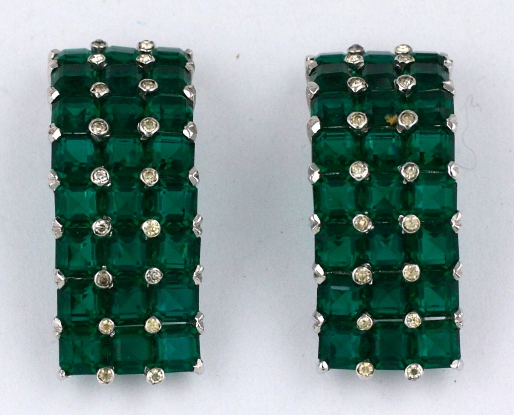 Lovely pair of deco fur clips with invisbly set faux emeralds and pastes. Meant to worn as a pair on the shoulder or opposing at the neckline. Lovely handset stones imitate real emeralds. Can be reconfigured in many variations. High quality casting