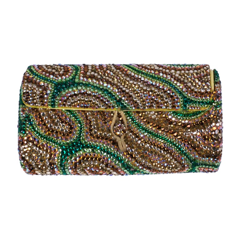 Unusual hand applied pave rhinestone clutch in  a swirl pattern of brown, green and aurora borealis stones. Button front closure. Satin base.1960s.<br />
Excellent condition.