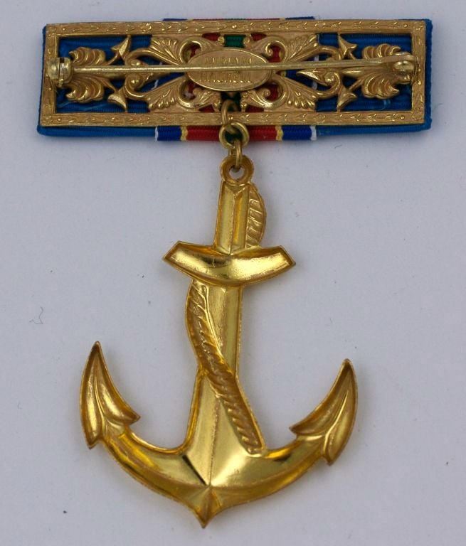 Summer nautical brooch by Miriam Haskell. Designed as a military badge with a grosgrain ribbon bar with a swinging gilt anchor. <br />
Signed Miriam Haskell circa 1960s<br />
2" x 3" High<br />
Excellent Condition