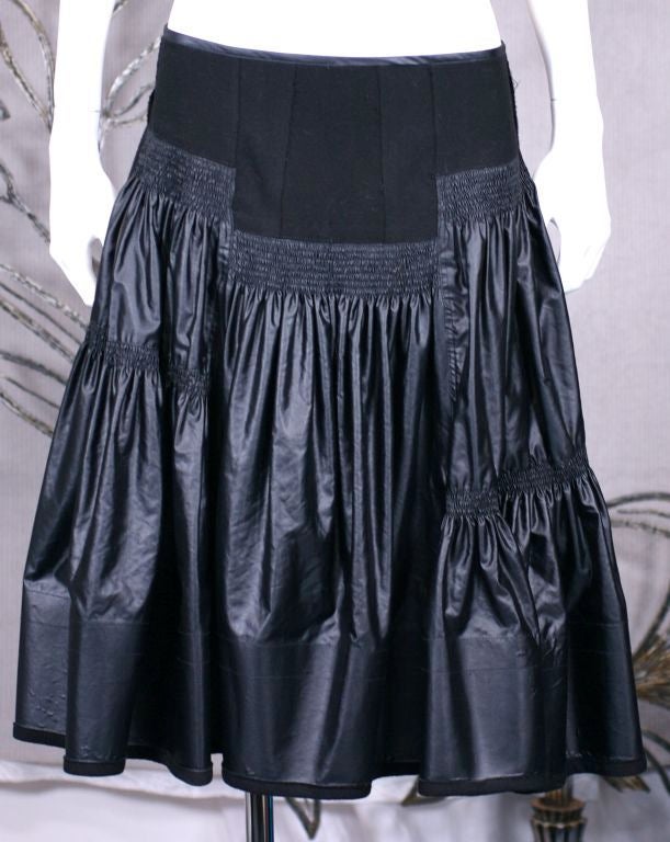 Donna Karan's urban ruffled skirt of felted wool mixed with glazed cotton. Fullness releases from hip yoke and at different gathered intervals. The hem is stiffened with wide border. Super full skirt. Side sip entry.
excellent condition.   1990s