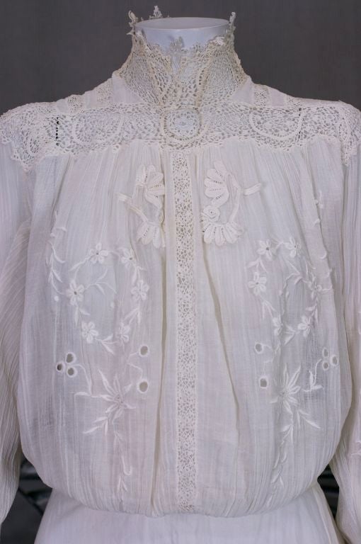 Beautiful Edwardian blouse with elaborate collar, cuffs and yoke of fine irish crochet lace. Floral hand embroidered motifs on crinkle cotton voile. Blouse buttons up the back with mother of pearl buttons and hand made button holes. Front is