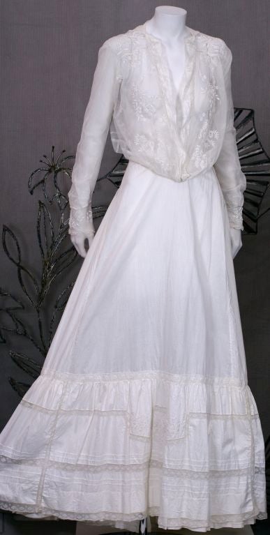 Lovely Edwardian cotton petticoat with multiple lace insertions and floral embroidery throughout deep flounce. Full gathered skirt with very full back sweep and slight train. Great for summer with wife beater tank and flip flops.<br />
Excellent