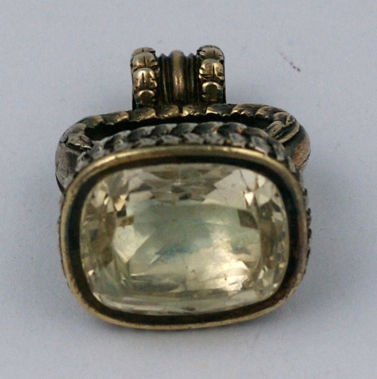 Lovely Georgian gilt metal fob with large foil backed citrine circa 1830s. The stone is beautifully faceted (20mm x 16mm)with natural inclusions visible. Detailed metal work scroll motifs with a patinaed finish which has both gold and silver