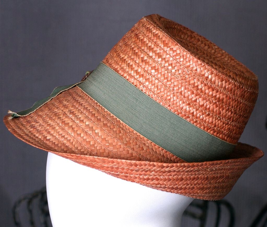 Charming straw hat made in Italy with butterfly and grosgrain trim circa 1950s. Pale pumpkin straw with brown straw decoration.<br />
Excellent condition.<br />
21